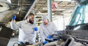 commercial truck technicians looking at truck engine