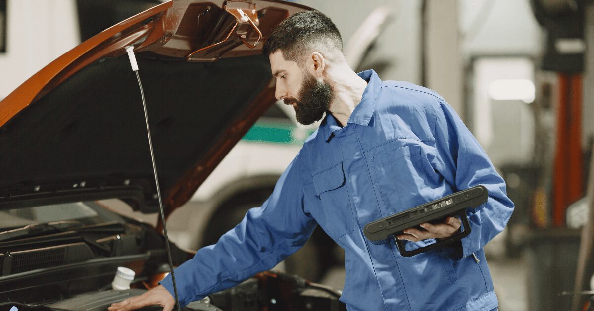 Mechanic running diagnostic tests on car