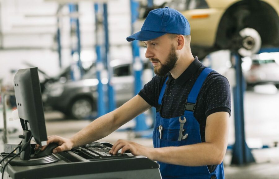 Autobody-shop-working-on-ADAS-flags-that-appeared-on-report-1200×770 technician diagnosing cars issues