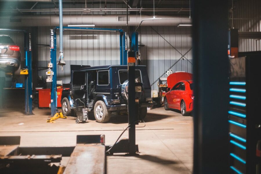 Jeep and sedan in body shop