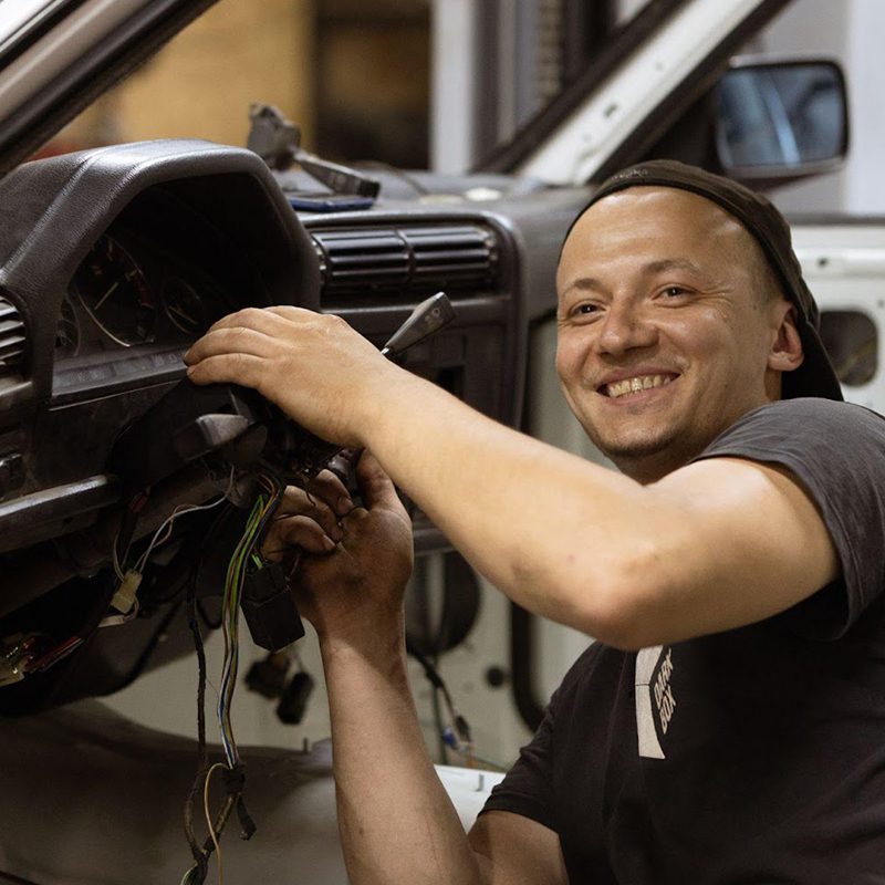 technician putting steering column back together