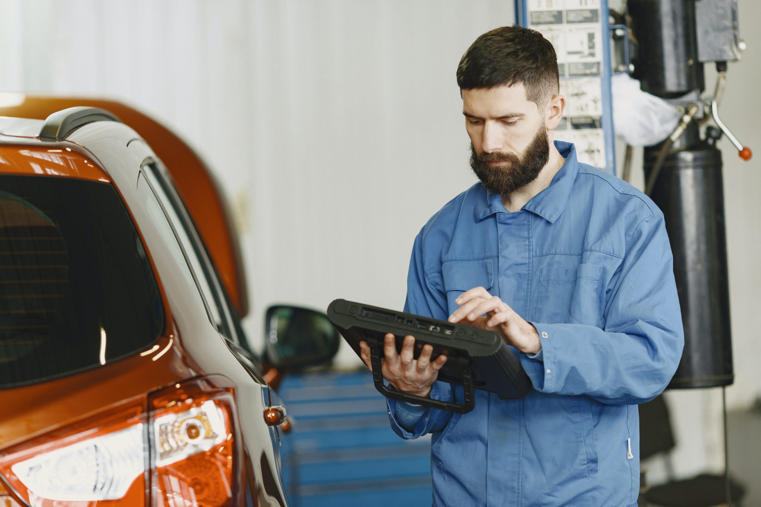 technician working on MaxiSYS tablet to diagnose what is wrong with care