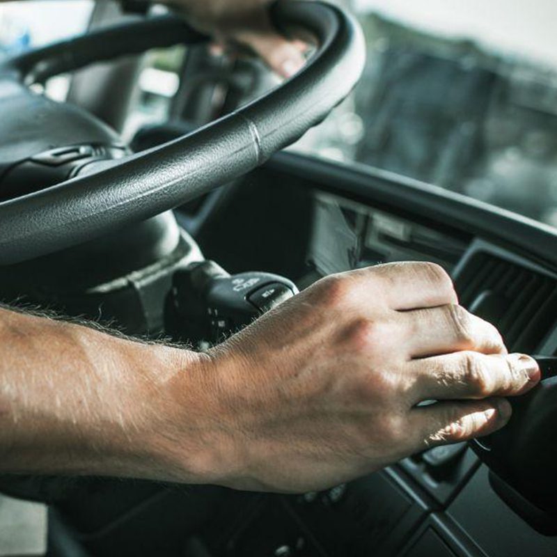 driver shifting gears in semi truck