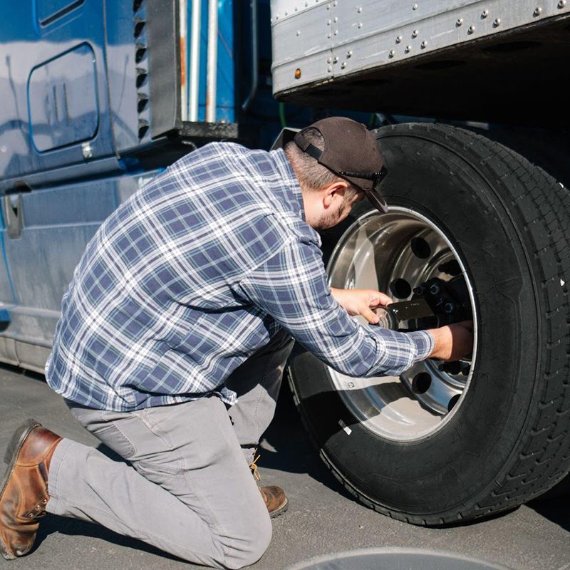 truck driver fixing tire