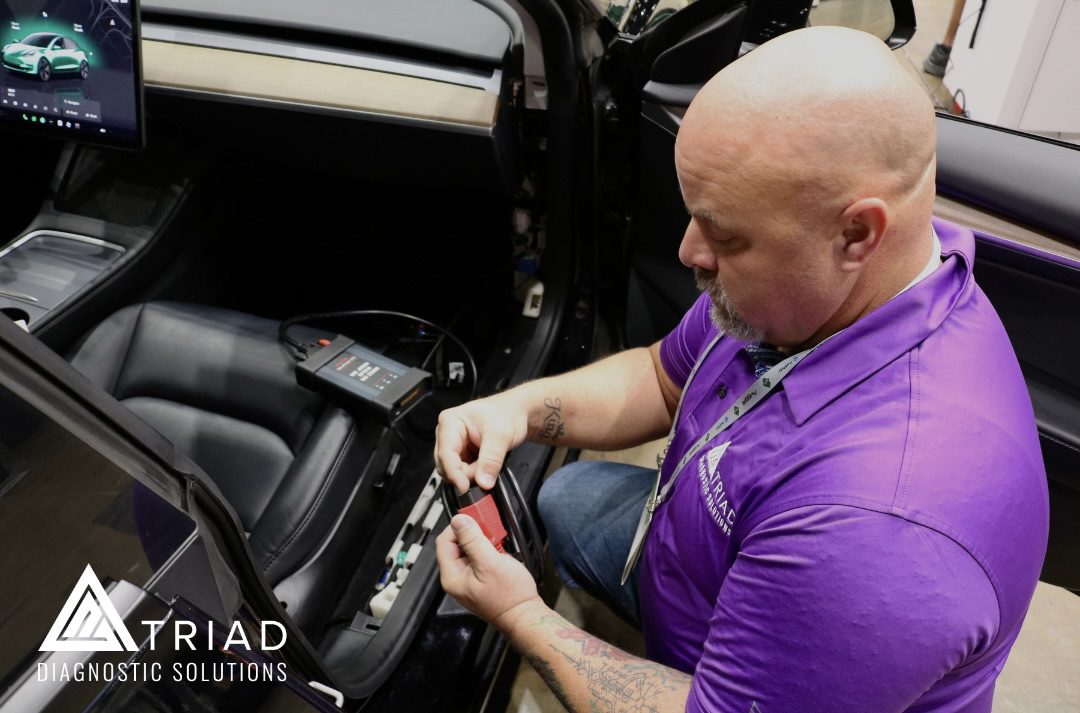 Triad Images – 11 triad diagnostic technician connecting automotive vehicle to perform diagnostics